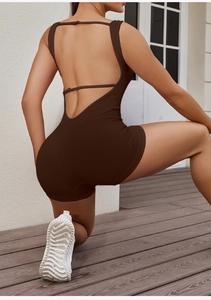 Deep brown ribbed backless yoga jumpsuit featuring thin straps and seamless texture