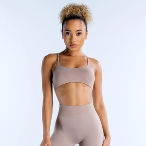 Seamless backless yoga set featuring high-waisted leggings and arched sports bra in taupe