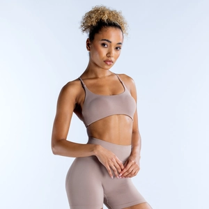 Detail of mocha seamless yoga set featuring thin strap sports bra and high-waisted shorts