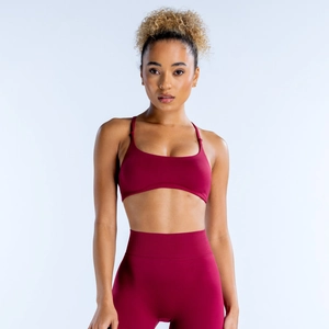 Close-up of seamless dark red sports bra and high-waisted leggings on a female model