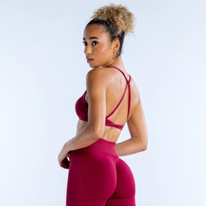 Detail of burgundy yoga set featuring criss-cross back sports bra and lifting leggings