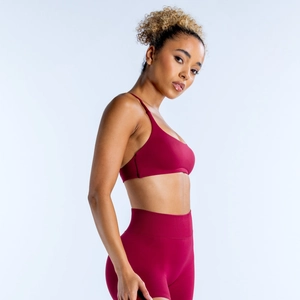 Seamless backless burgundy yoga set including a thin strap sports bra and high-waist leggings