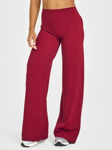 Detail of high-waisted dark red wide-leg yoga pants showing smooth fabric and stitching