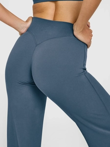 Detailed view of dark blue high-waisted yoga pants with peach-butt lifting seam design