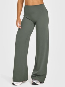 Detail view of high-waisted dark green wide-leg yoga pants with matte texture