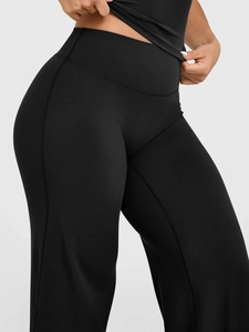 Detail view showing high-waisted elastic waistband of black yoga pants for fitness