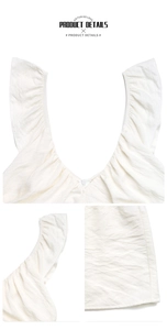 Detail of white dress featuring tiered ruffles on shoulders and a textured V-neckline