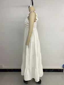 Detail showing white tiered ruffle sundress with natural texture and layered cake skirt