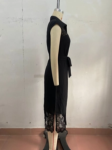 Detail of black sleeveless lace dress with turn-down collar and waist tie belt
