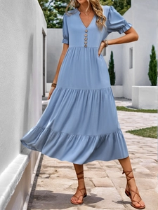 Detail view of light blue V-neck maxi dress with wooden buttons and puff sleeve design