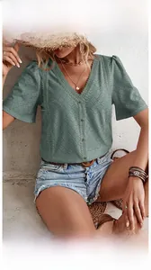 Detailed view of dark green V-neck lace hollow blouse with bohemian chic patterns