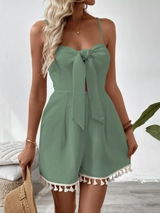 Sage green waffle knit romper with delicate spaghetti straps and bow detail