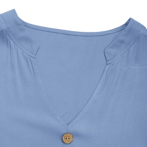 Detail of light blue V-neck shirt with small stand collar and wooden button texture