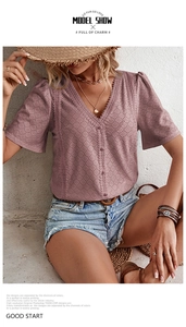 Detail shot of dusty rose v-neck blouse with eyelet embroidery and lace trim textures