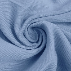 Detailed macro view of soft light blue jersey fabric texture with fine knitted ripples