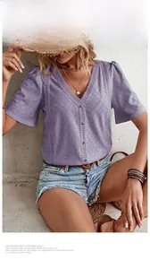 Detail of purple V-neck eyelet shirt featuring delicate lace embroidery and short sleeves
