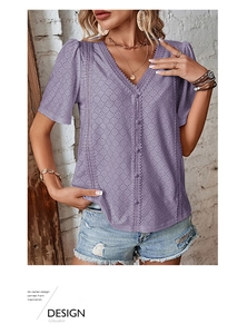 Detail of lavender V-neck blouse featuring intricate eyelet embroidery and scalloped edges