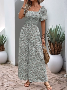 Detail of smocked square neck and puff sleeves on a floral wide-leg jumpsuit