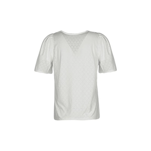 Close-up of white short-sleeved blouse featuring delicate eyelet embroidery and V-neckline