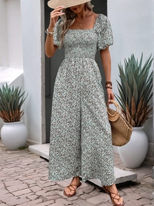 Detail of square neck floral romper with smocked bodice and puff sleeves in light green