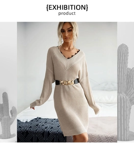 Detail of V-neck knit dress featuring black lace trim and waist belt with gold chain