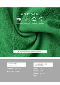 Detail of green summer jumpsuit safety fabric with soft vertical wavy pleated texture
