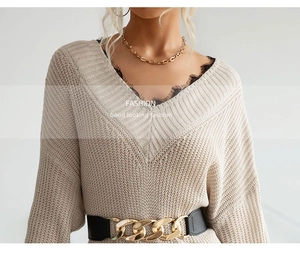 Detail of V-neck knit sweater with black eyelash lace trim and gold chain belt accessory