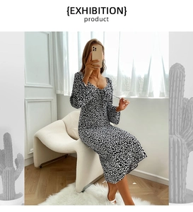 Detail of V-neck floral print dress with long sleeves and high waist design