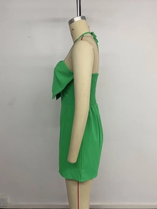 Detail of green halter neck mini dress with large bow and smocked back panel
