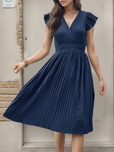 Detail view of the V-neckline and flutter sleeves on a dark blue pleated dress