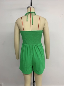 Detail view of women green summer romper featuring elastic smocking and halter tie back