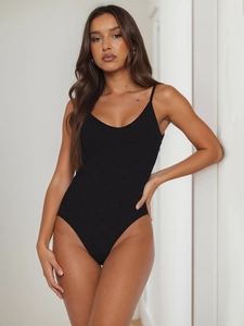 Close-up of black thin strap bodysuit with bodycon fit and premium elastic fabric texture