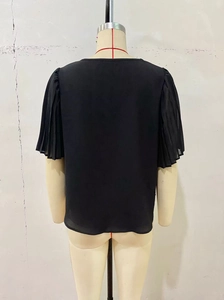 Detail of black puff sleeves with pleated texture and round neck design on women top