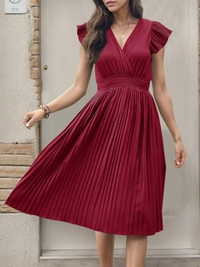 Detail of elegant wine red pleated dress with flutter sleeves and an elastic waist design