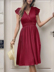 Detail of burgundy pleated summer dress with deep V-neck and ruffled short sleeves