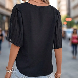 Back view of a black puff sleeve blouse with pleated details and a round neckline