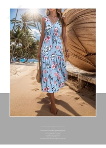 Detail of light blue floral summer dress featuring V-neck and drawstring waist on a beach