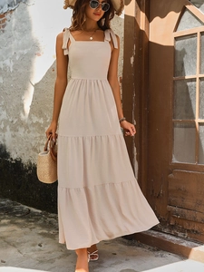 Elegant beige tiered maxi dress with bow straps and textured fabric for summer vacation