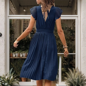 Elegant navy blue pleated short sleeve dress with deep V-back and tie detail back view