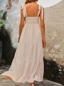 Elegant backless beige tiered maxi dress with adjustable bow straps for summer vacation