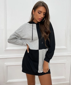 Detail of color block knitted hoodie dress with adjustable drawstring and ribbed cuffs