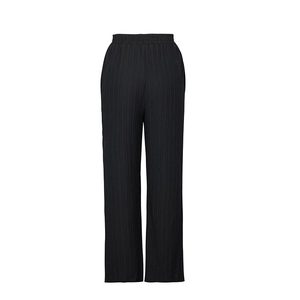 Close-up of high-waisted black wide-leg trousers featuring vertical pleated fabric texture