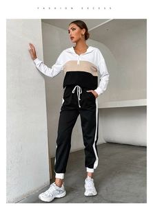 Close-up of color-block hooded sweatshirt with half-zipper and drawstring sweatpants