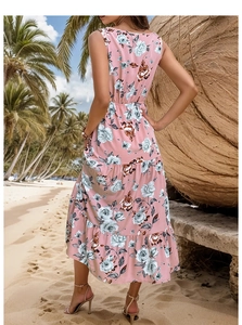 Floral print sleeveless maxi dress with tiered ruffles against tropical beach background