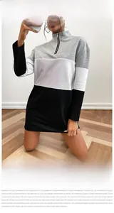 Detail of color-block sweatshirt dress featuring a half-zip stand collar and long sleeves
