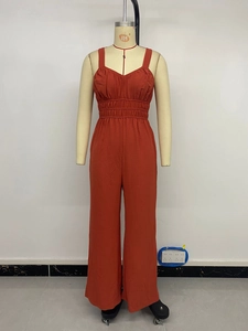Detail of high-waisted elastic waist on rust red V-neck wide leg jumpsuit
