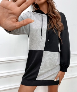 Detail of hooded knit dress with grey and black color-block design and ribbed cuffs