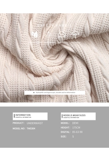 Macro detail of cream knit underwaist showing soft textured cable stitch fabric