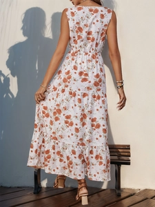 Rear view of tiered floral summer dress with orange flower print on cream fabric