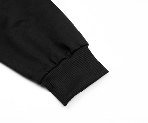 Close-up of high-density knit black ribbed cuff with neat and precise stitching detail